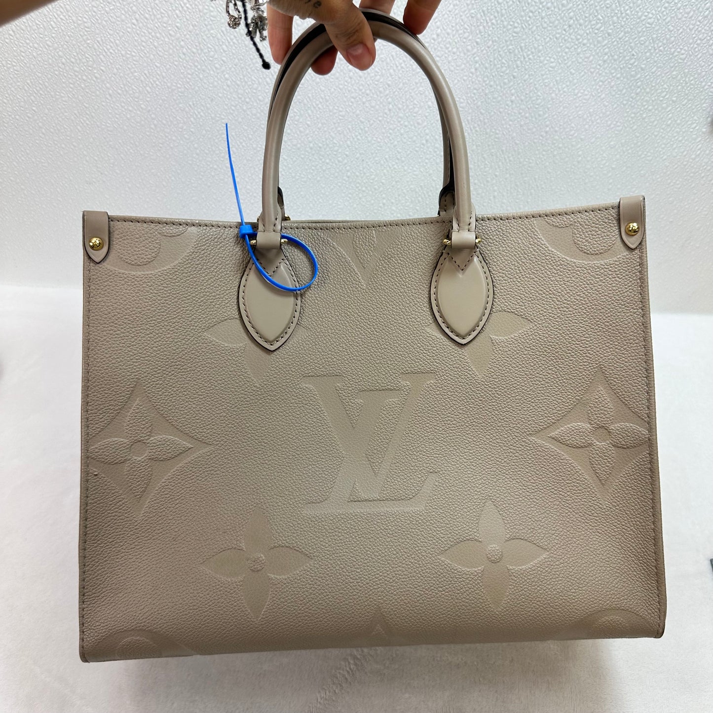 OnTheGo MM tote bag Tourterelle (turtledove) beige Monogram Empreinte leather Handbag Luxury Designer By Louis Vuitton, Size: Medium