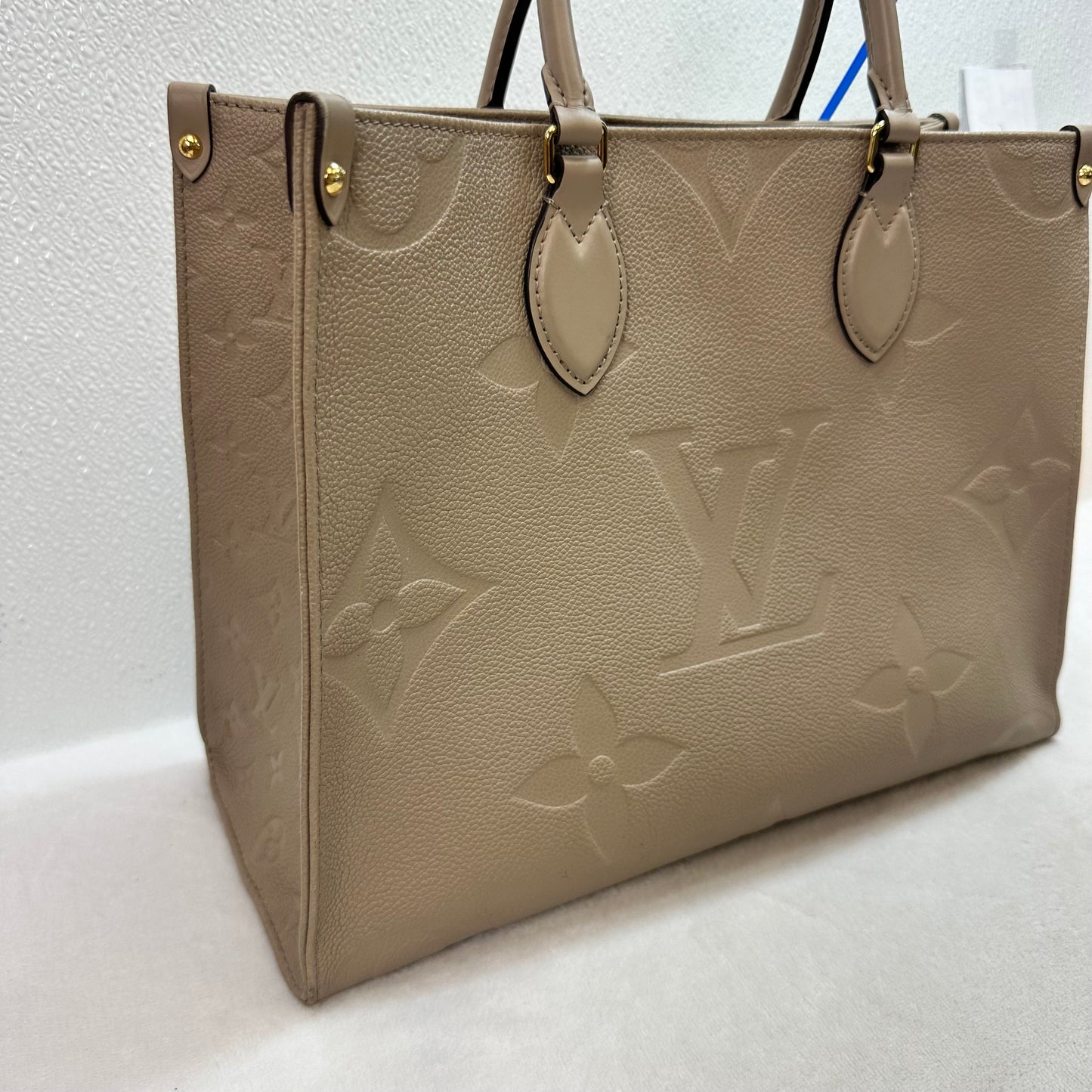 OnTheGo MM tote bag Tourterelle (turtledove) beige Monogram Empreinte leather Handbag Luxury Designer By Louis Vuitton, Size: Medium